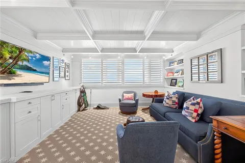 a living room with furniture and a floor to ceiling window