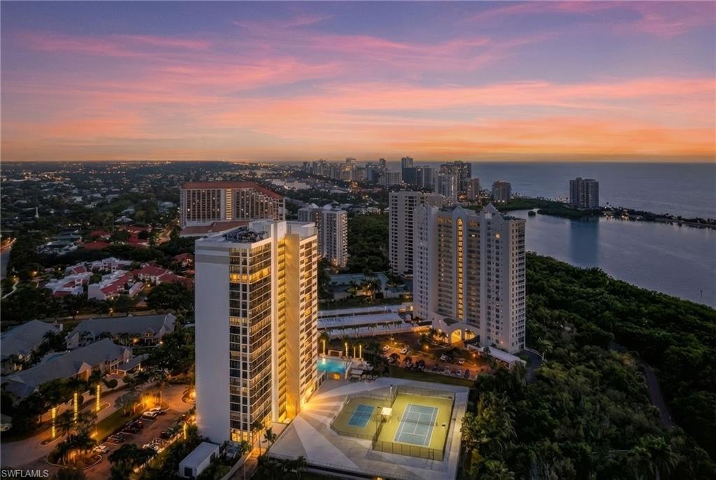 5601 Turtle Bay Drive, Unit 2104 Naples, FL 34108 - Photo 29 of 31 Aerial view at dusk of a water view and a view of city