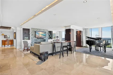 a living room with furniture and a dining table with kitchen view