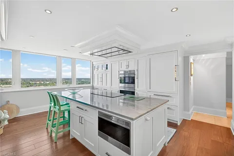 a open kitchen with stainless steel appliances granite countertop a stove and a refrigerator