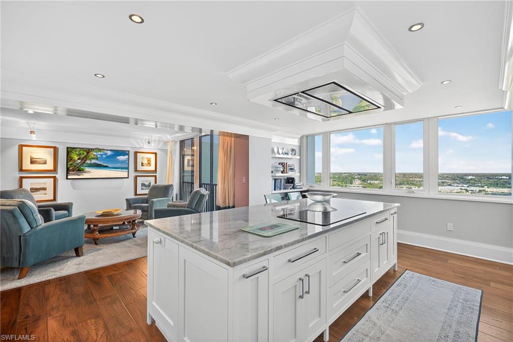 5601 Turtle Bay Drive, Unit 2104 Naples, FL 34108 - Photo 31 of 31 Kitchen with light stone counters, open floor plan, white cabinetry, dark wood-style flooring, and recessed lighting