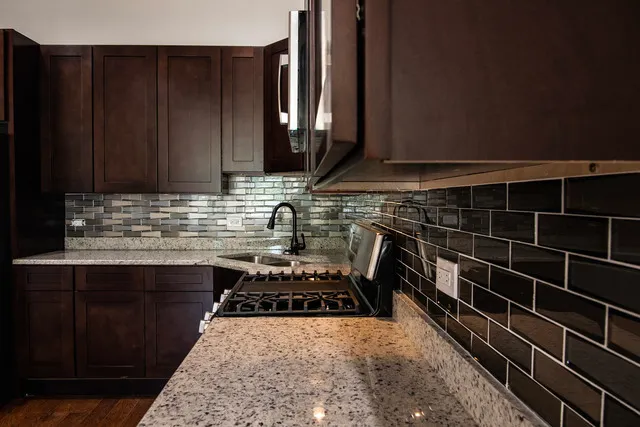 a kitchen with a sink stove and cabinets