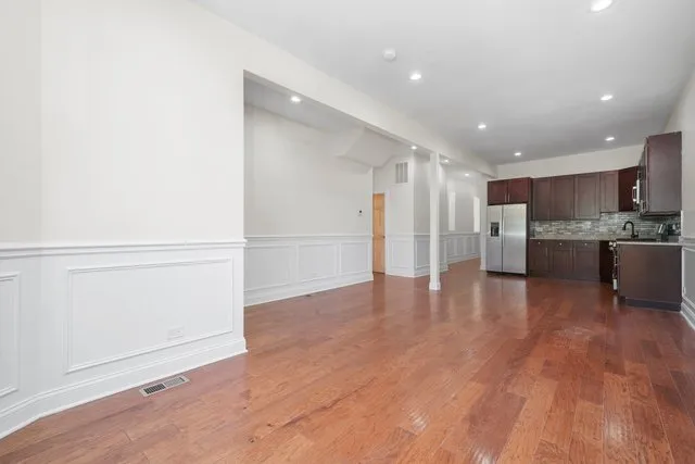 a view of kitchen with wooden floor and electronic appliances