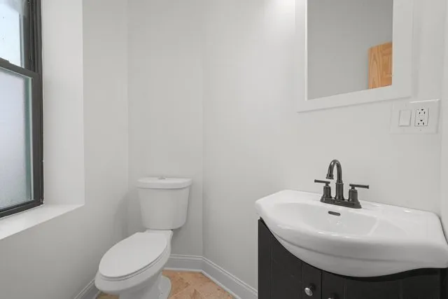 a bathroom with a sink a toilet and mirror