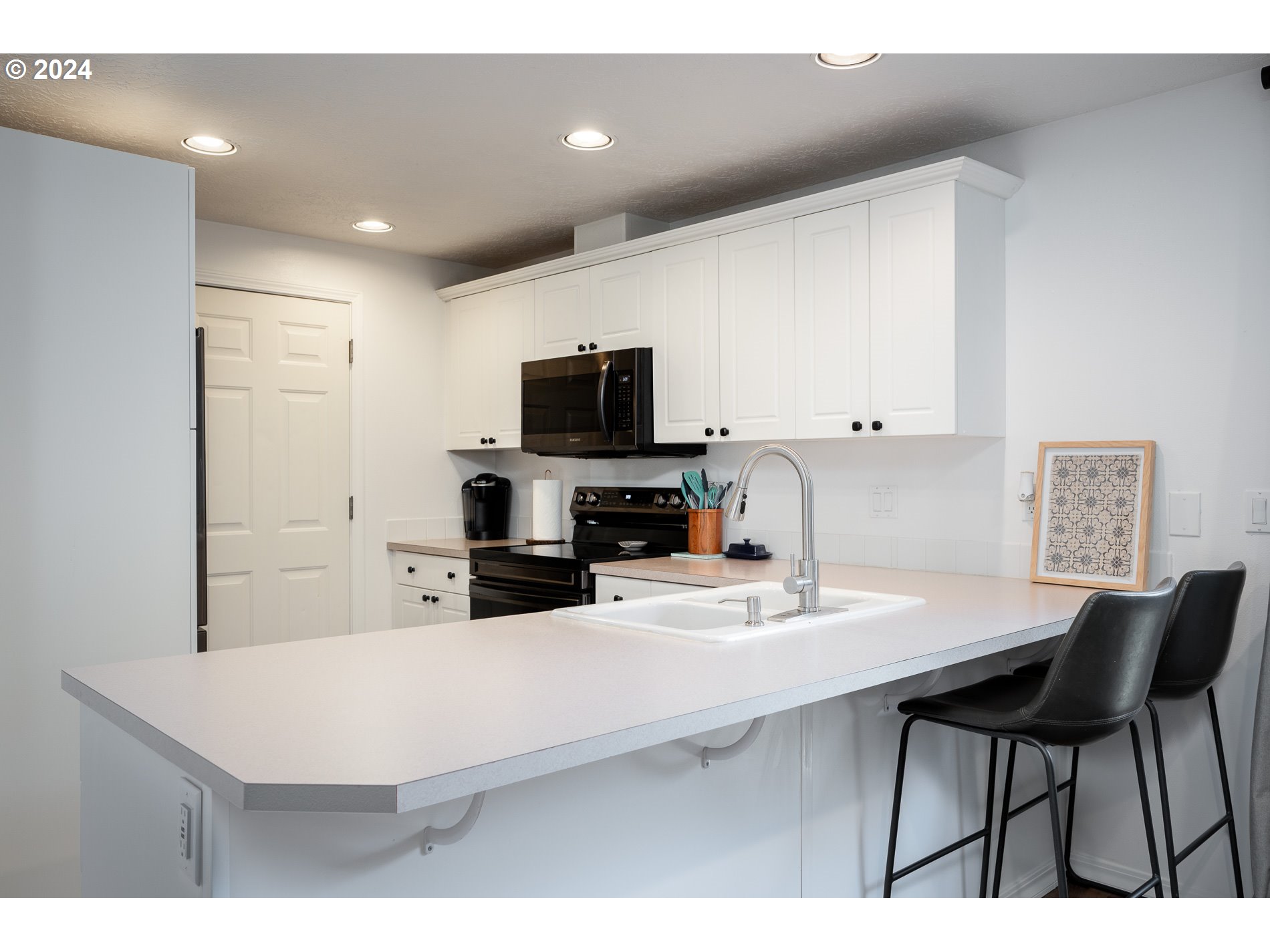 18074 Rachael Drive Sandy, OR 97055 - Photo 13 of 40 a kitchen with a dining table chairs and a refrigerator
