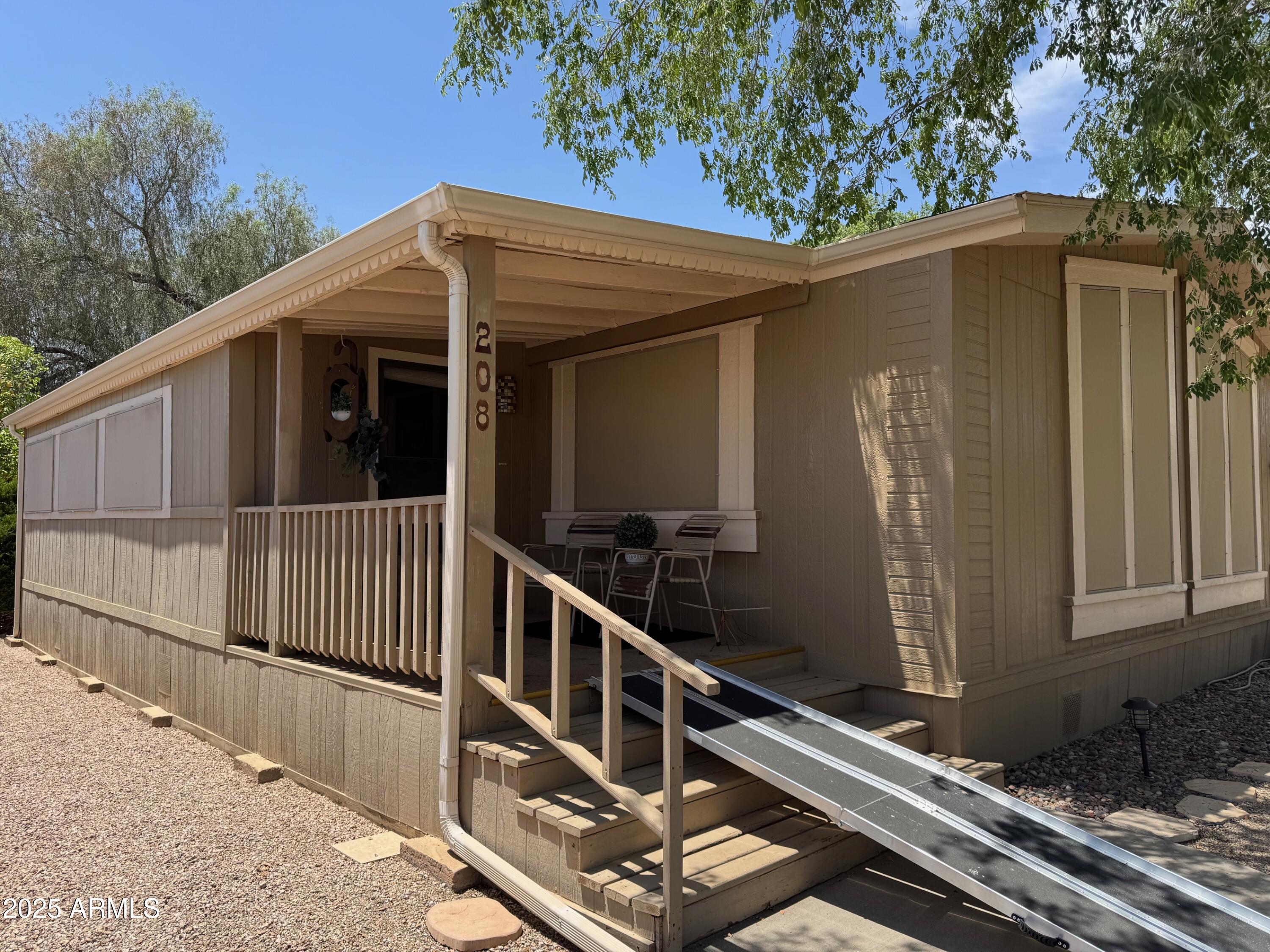 3901 East Pinnacle Peak Road, Unit 208 Phoenix, AZ 85050 - Photo 15 of 22 a view of a balcony with chairs and wooden fence