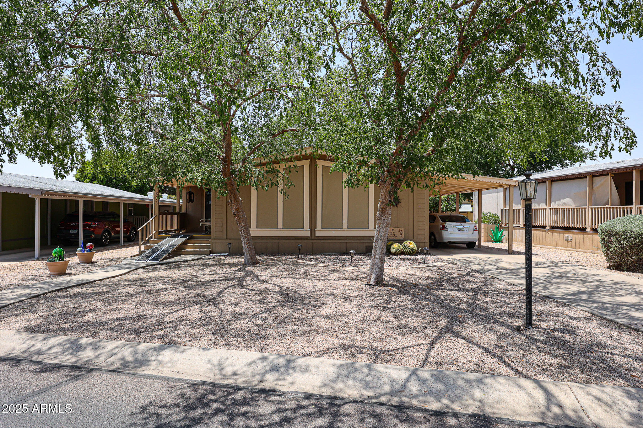 3901 East Pinnacle Peak Road, Unit 208 Phoenix, AZ 85050 - Photo 2 of 22 a house with trees in the background