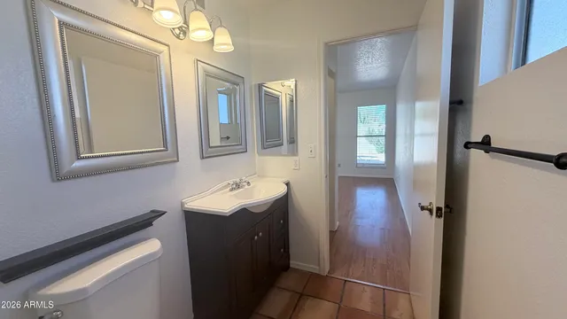 a bathroom with a sink a toilet and mirror