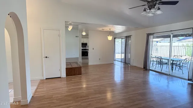 a view of empty room with a fireplace and wooden floor