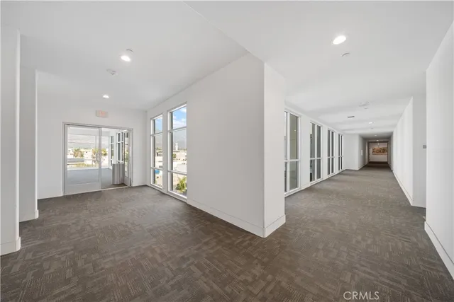 a view of a big room with windows and closet