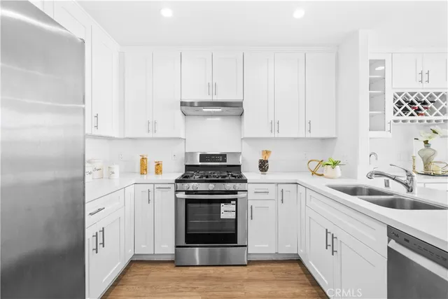 a kitchen with a sink and a potted plant
