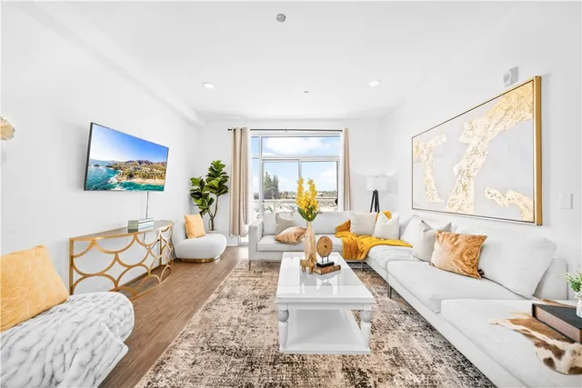 a living room with furniture and wooden floor
