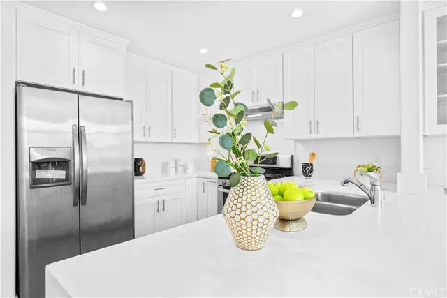 a bedroom with a bed and a potted plant