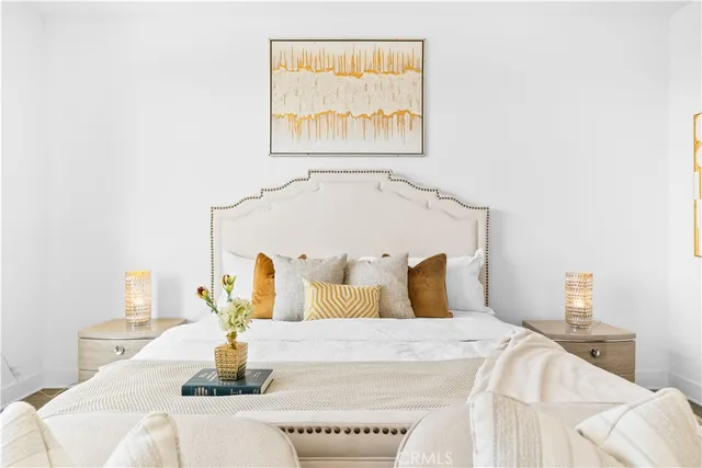 a view of a hallway with wooden floor and a bathroom