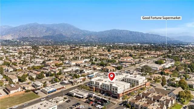 a view of an empty room with closet and a window