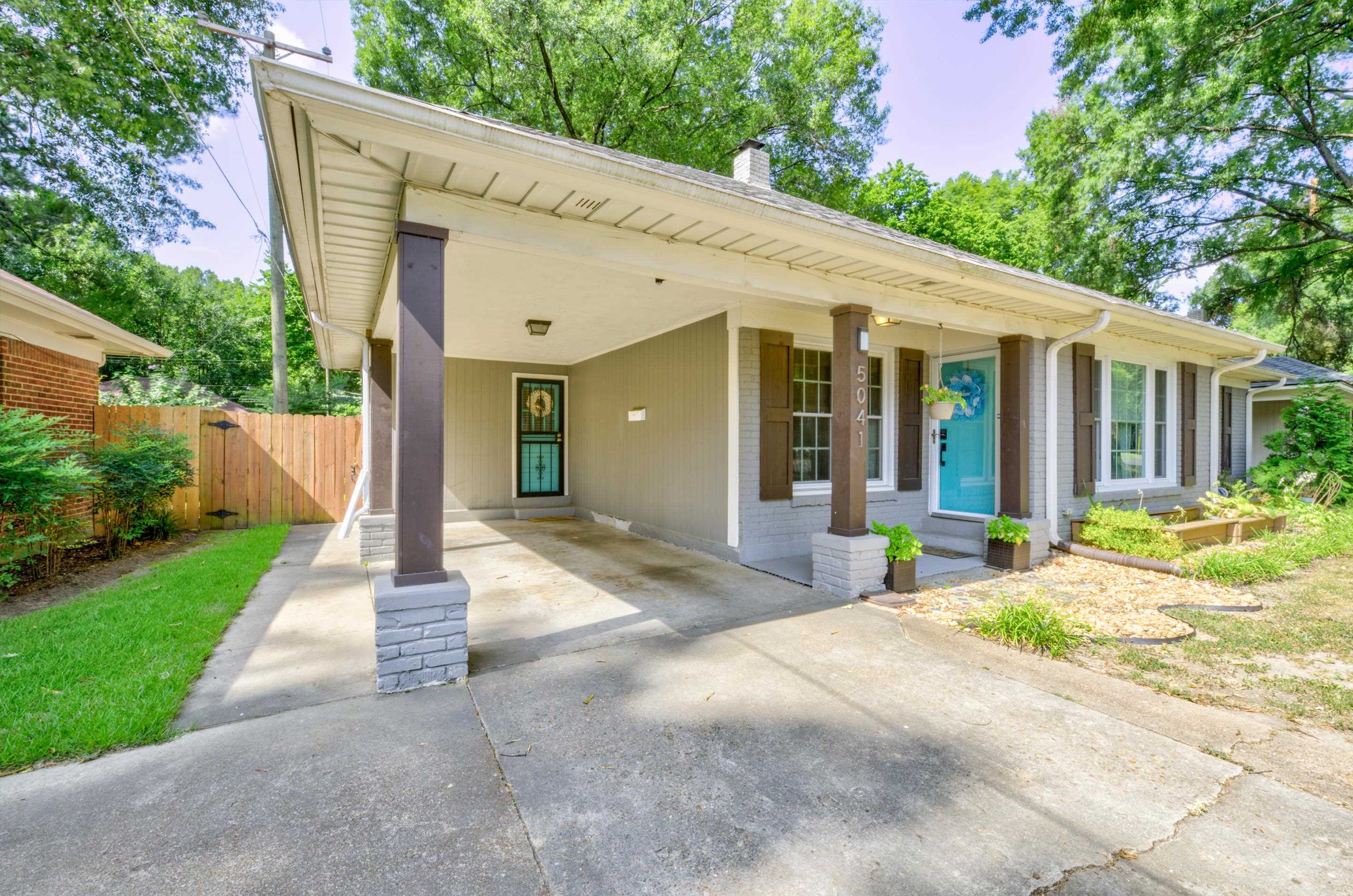 5041 Quince Road Memphis, TN 38117 - Photo 23 of 28 a front view of a house with a yard and potted plants