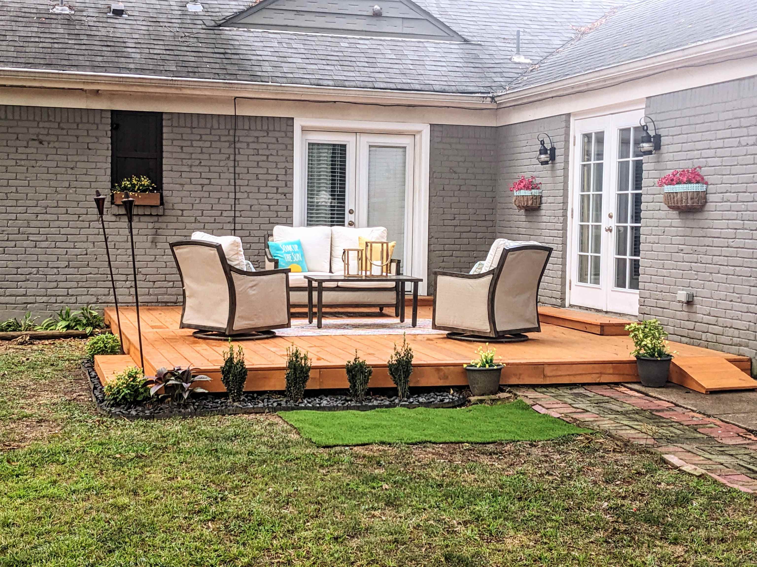 5041 Quince Road Memphis, TN 38117 - Photo 3 of 28 a front view of a house with garden and sitting area