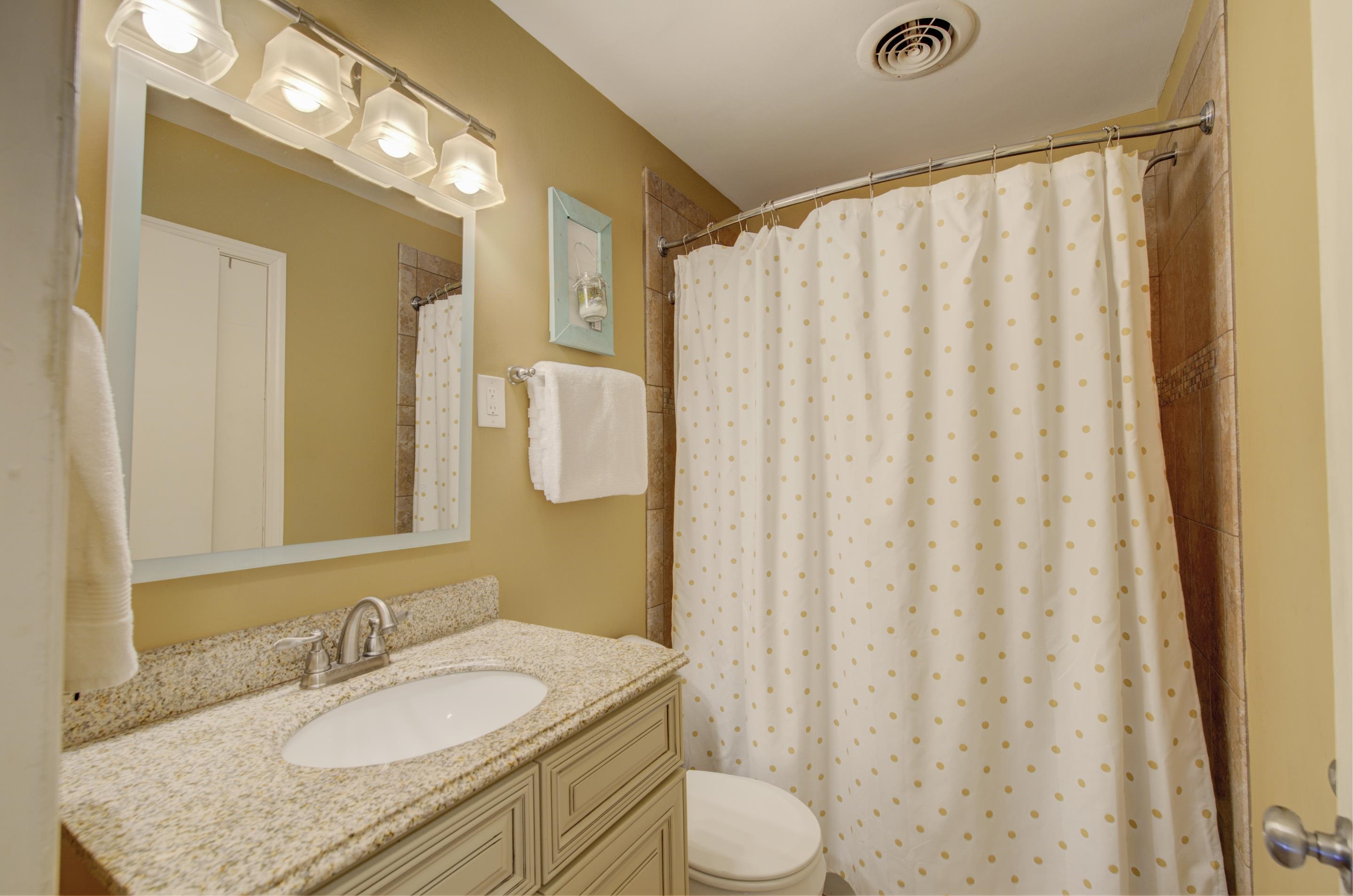 5041 Quince Road Memphis, TN 38117 - Photo 10 of 28 a bathroom with a granite countertop sink and a mirror