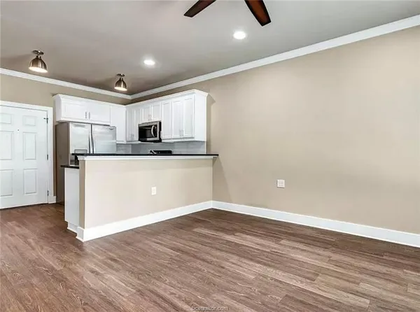 a view of a kitchen with microwave and cabinets