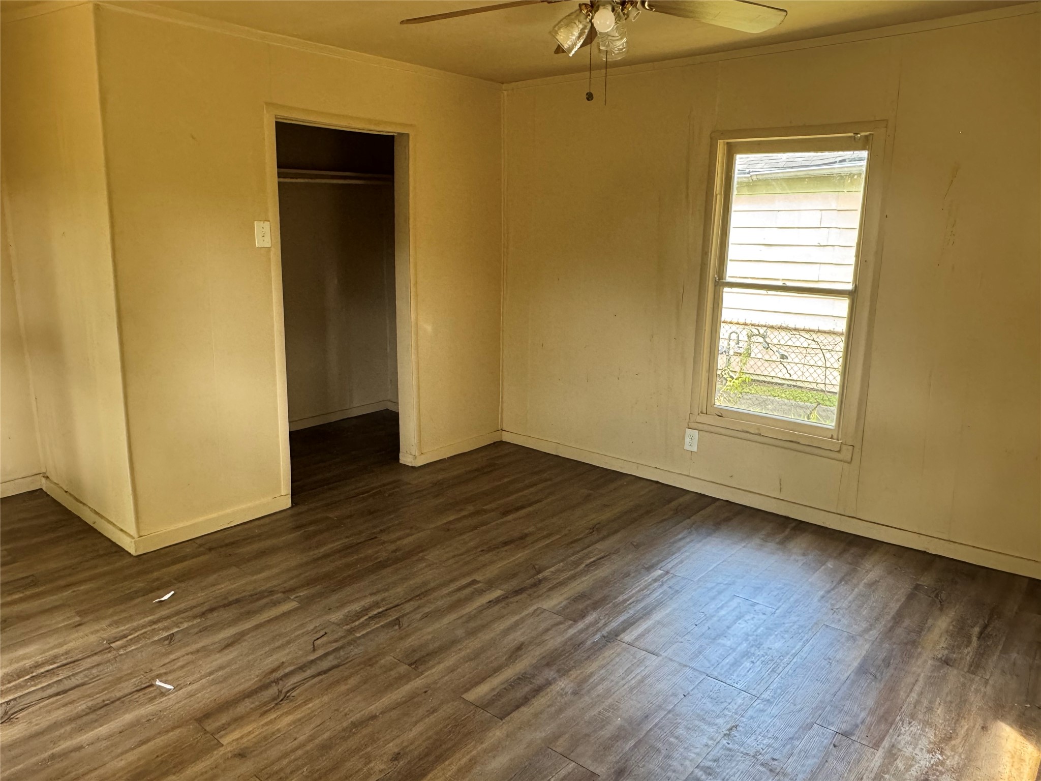 606 East 42nd Street Houston, TX 77022 - Photo 6 of 14 a view of an empty room with wooden floor and a window