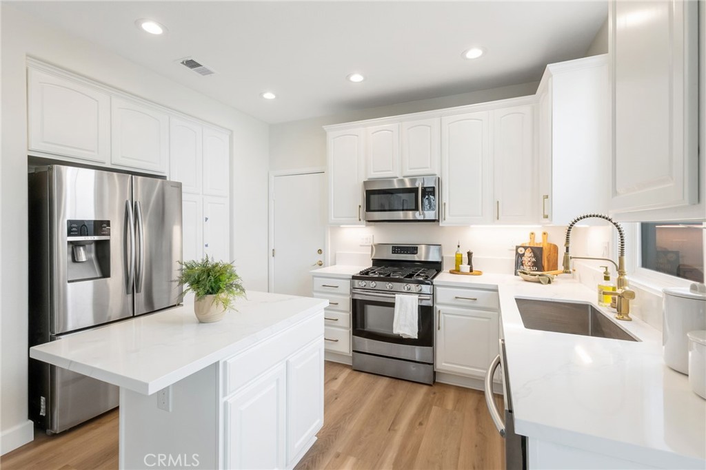 1 Tarleton Lane Ladera Ranch, CA 92694 - Photo 17 of 58 a kitchen with stainless steel appliances a stove refrigerator sink and microwave