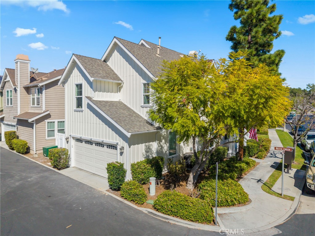 1 Tarleton Lane Ladera Ranch, CA 92694 - Photo 4 of 58 a view of a white house with a tree and plants next to a road