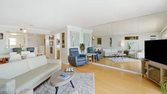 a bedroom with furniture and a flat screen tv