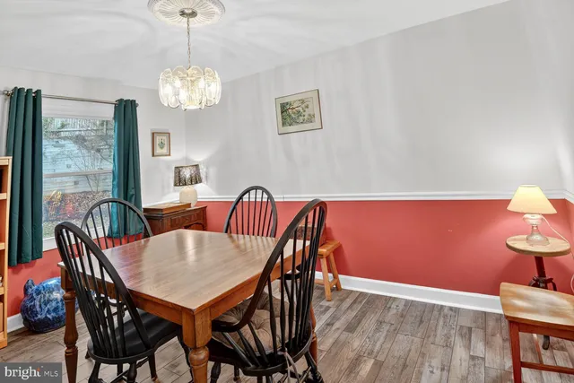 a view of a dining room with furniture wooden floor and chandelier