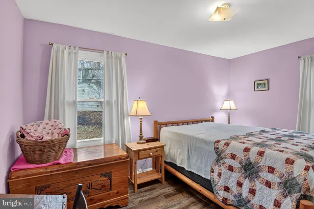 a bedroom with a bed and window