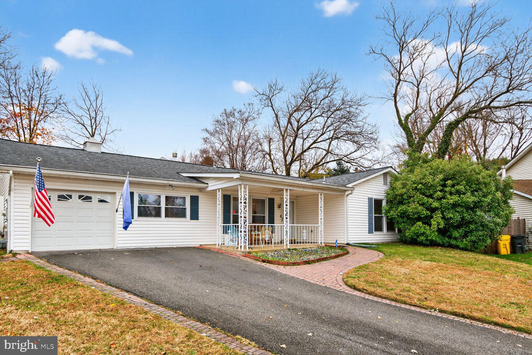 7908 South Cartier Court Severn, MD 21144 - Photo 2 of 27 a view of a white house with a large tree