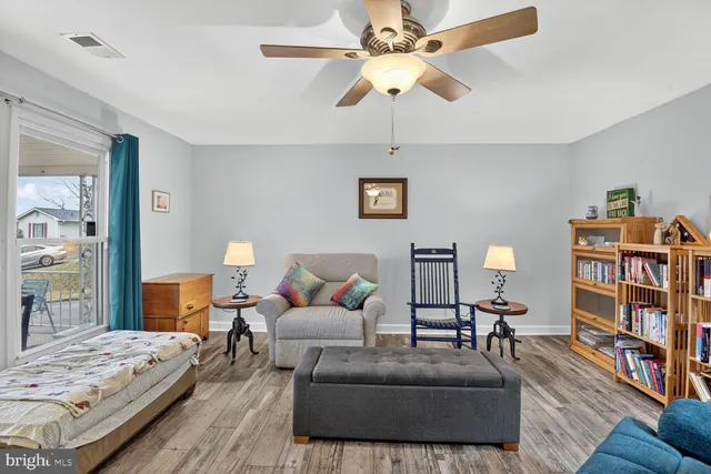 a living room with furniture and a book shelf