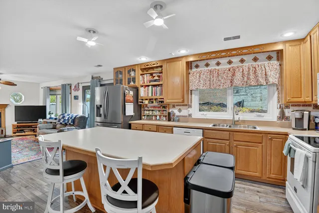 a large kitchen with a table and chairs