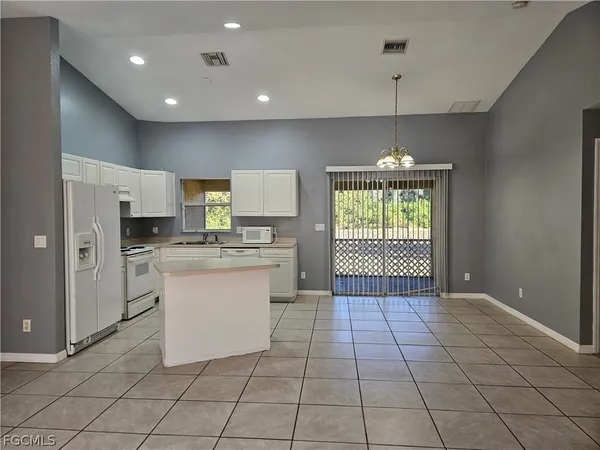 a kitchen with a refrigerator a stove a microwave and a counter top space