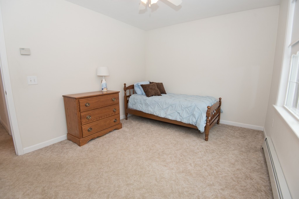 83 Colburn Road Charlton, MA 01507 - Photo 19 of 30 a room with a bed and a lamp on desk