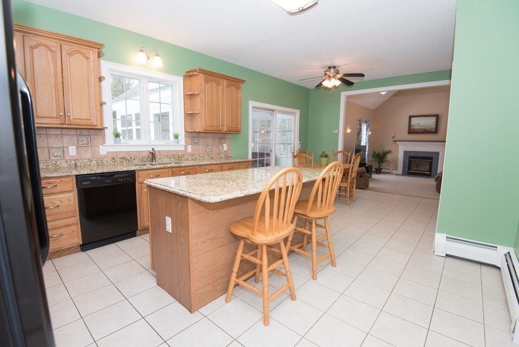 83 Colburn Road Charlton, MA 01507 - Photo 7 of 30 a dining hall with granite countertop a stove a sink and a dining table view