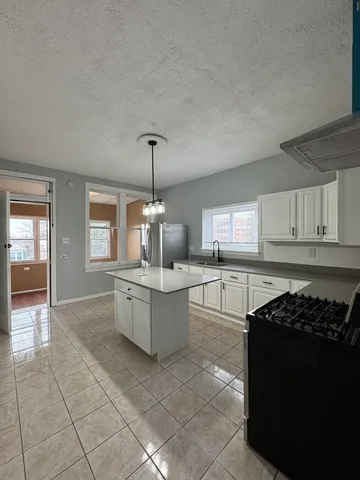 a kitchen with stainless steel appliances granite countertop a sink counter space and cabinets