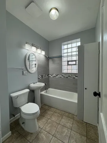 a bathroom with a toilet a sink and bathtub