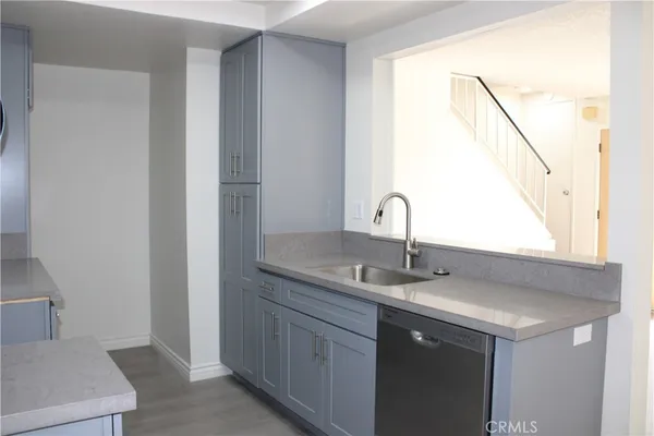 a kitchen with a sink and a mirror