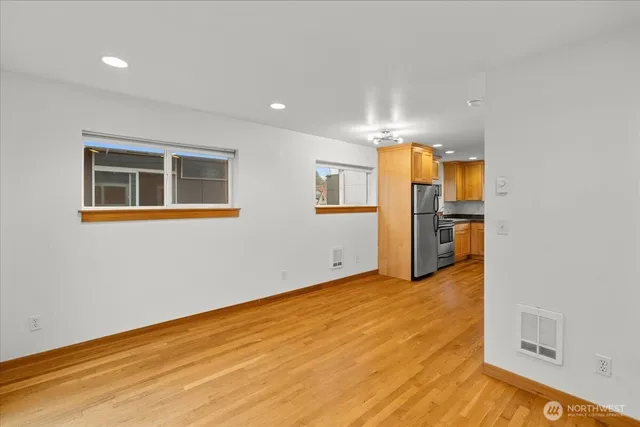 a view of a kitchen with a refrigerator cabinet and a window