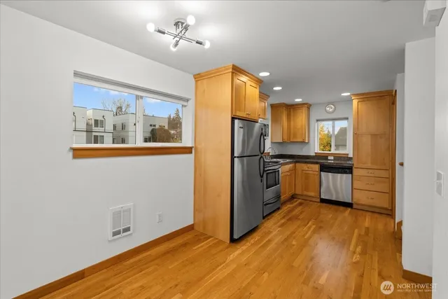 a kitchen with stainless steel appliances a refrigerator and a stove top oven