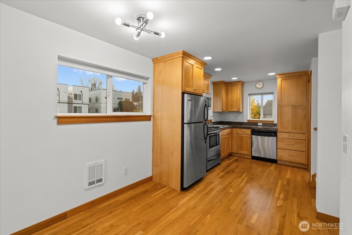 6348 34th Avenue Southwest, Unit C Seattle, WA 98126 - Photo 13 of 26 a kitchen with stainless steel appliances a refrigerator and a stove top oven