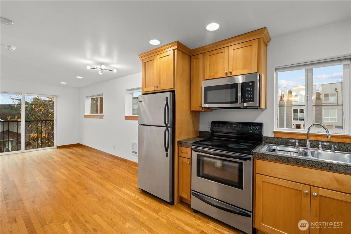 6348 34th Avenue Southwest, Unit C Seattle, WA 98126 - Photo 18 of 26 a kitchen with a refrigerator stove and microwave