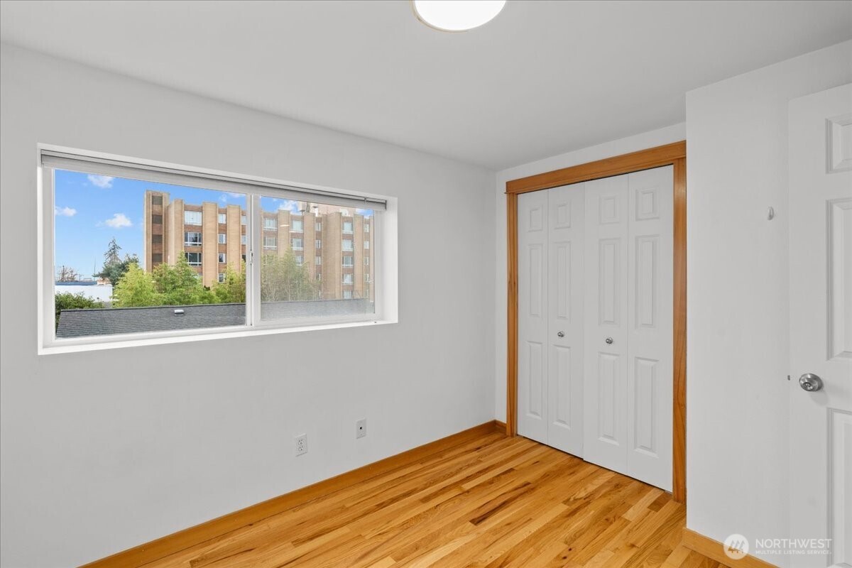6348 34th Avenue Southwest, Unit C Seattle, WA 98126 - Photo 24 of 26 a view of empty room with window and wooden floor