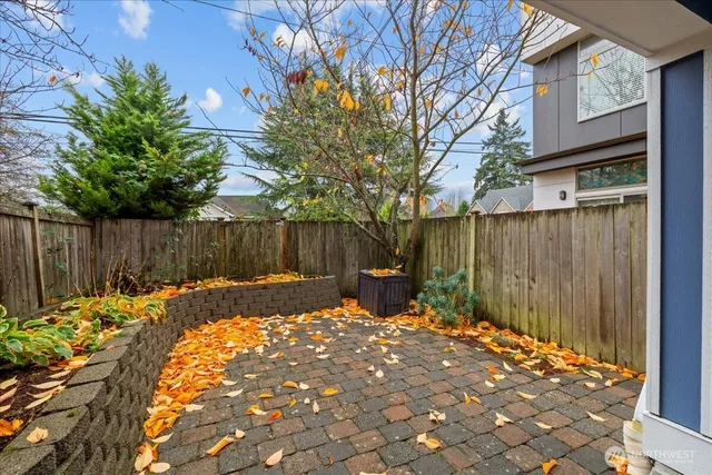 a backyard of a house with table and chairs