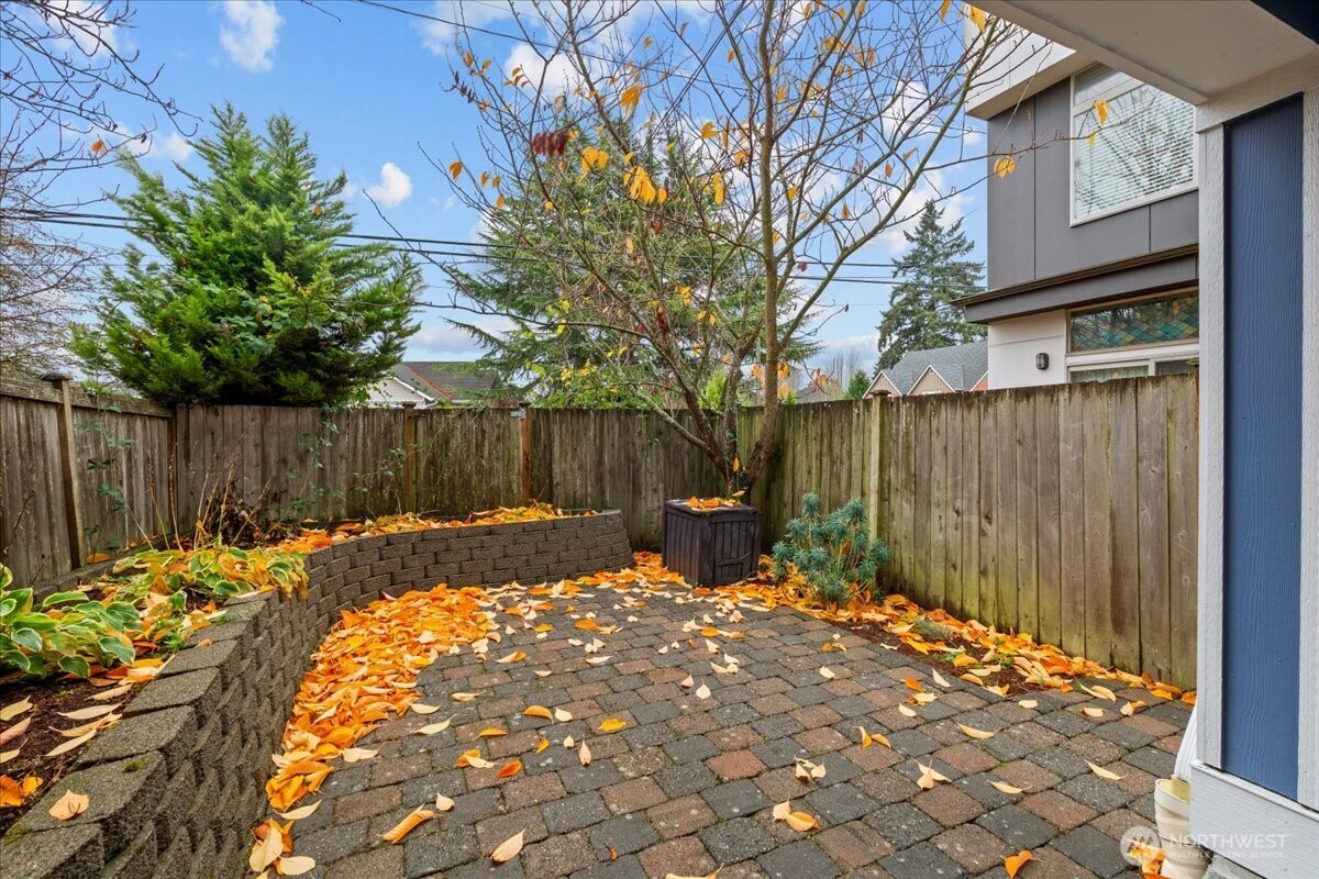 6348 34th Avenue Southwest, Unit C Seattle, WA 98126 - Photo 26 of 26 a backyard of a house with table and chairs