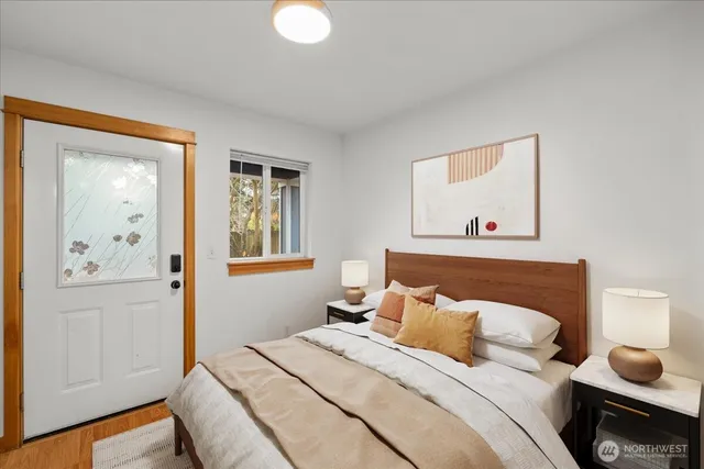 a bedroom with a bed and a window