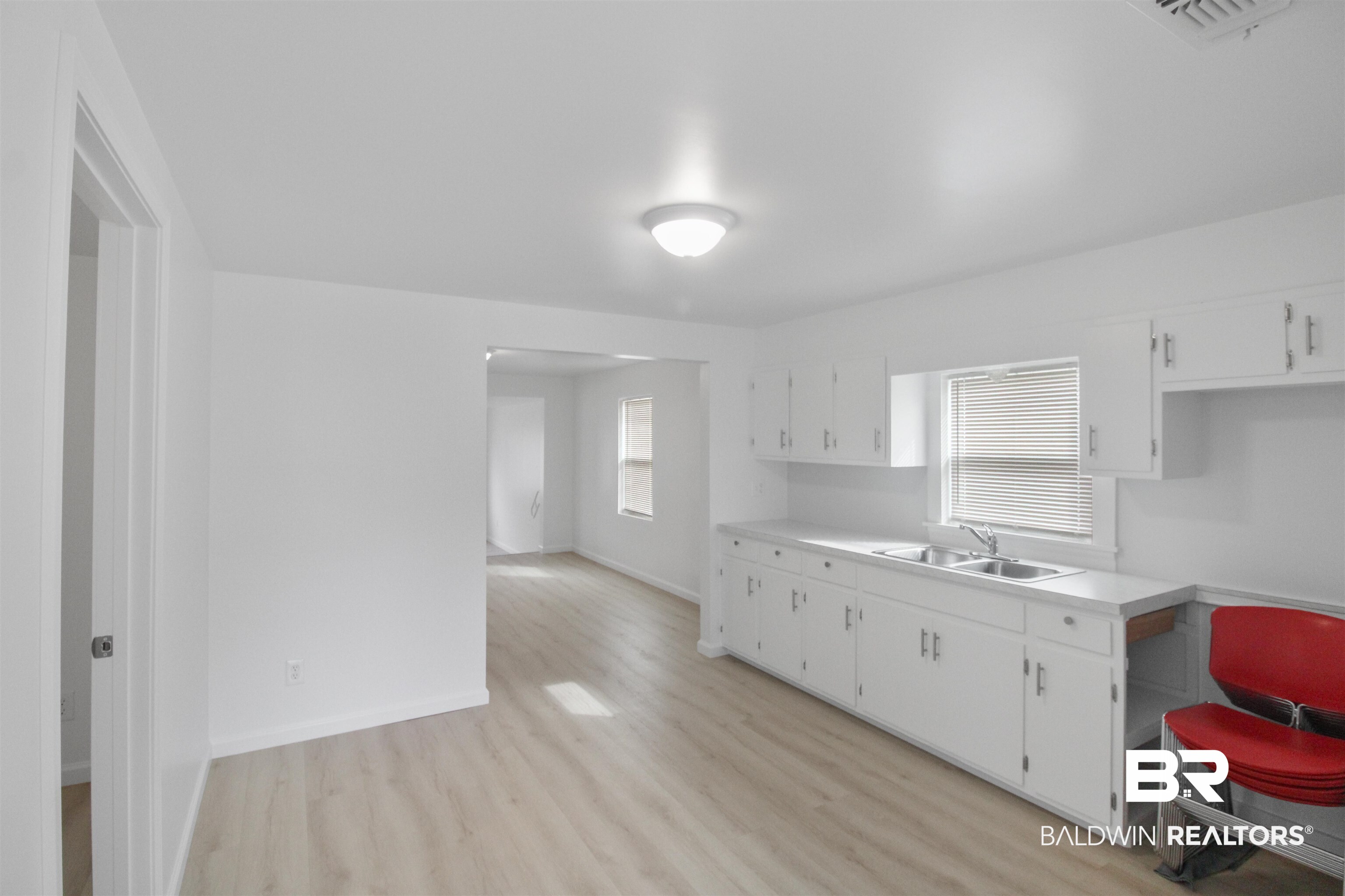 17622 Brewer Road Foley, AL 36535 - Photo 2 of 26 Kitchen featuring light countertops, light wood-type flooring, and white cabinets