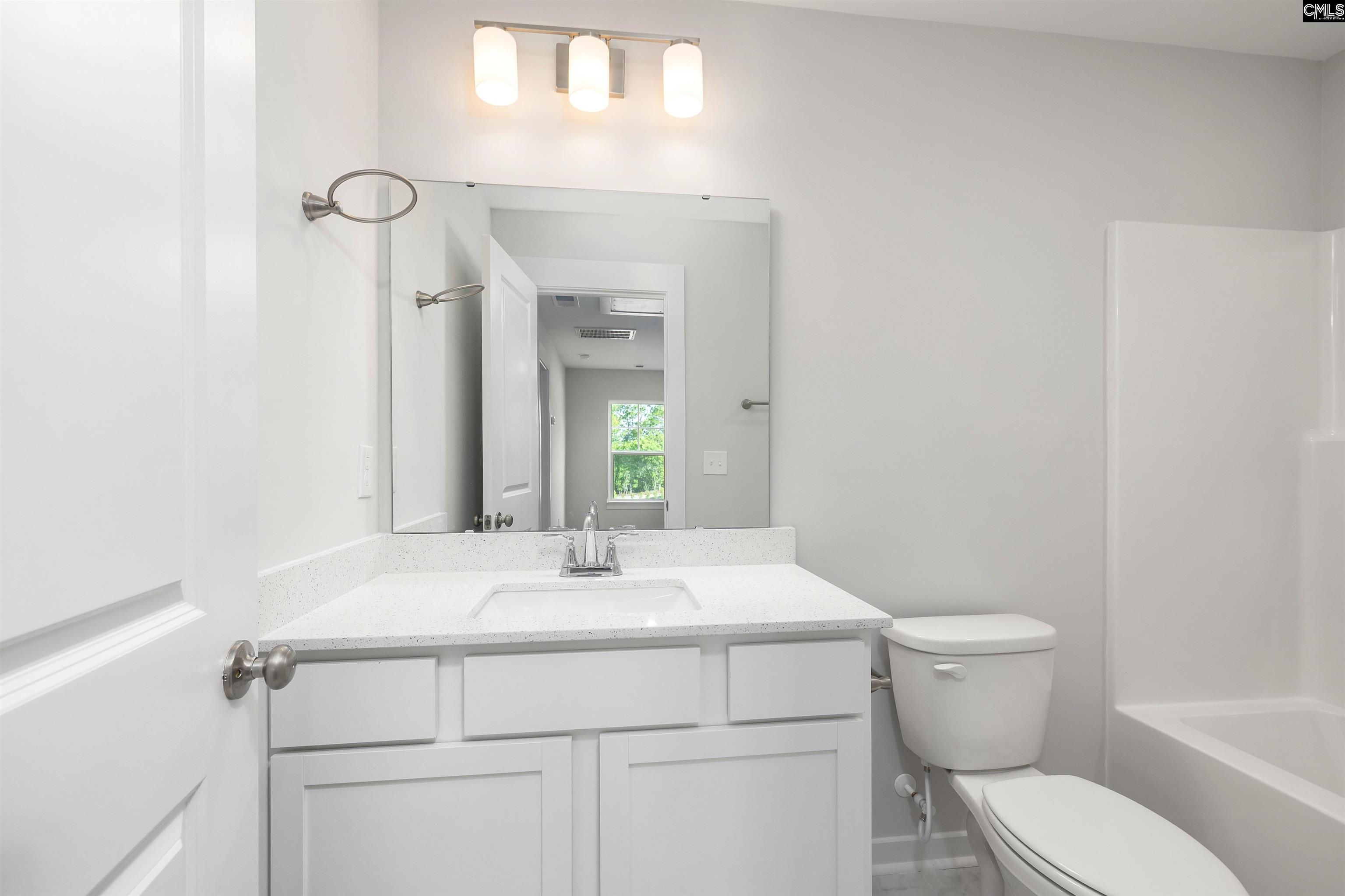 32 Fawn Spot Court Elgin, SC 29045 - Photo 24 of 28 a bathroom with a sink a toilet and mirror