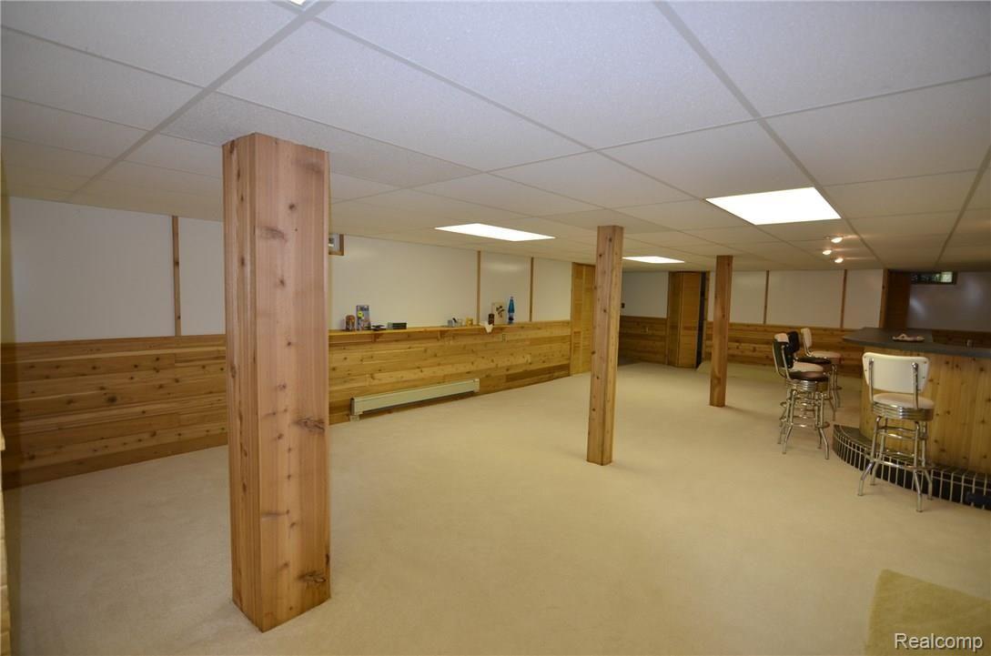 3800 Clyde Road Holly, MI 48442 - Photo 20 of 30 FULL FINISHED LOWER LEVEL WALK OUT & BAR