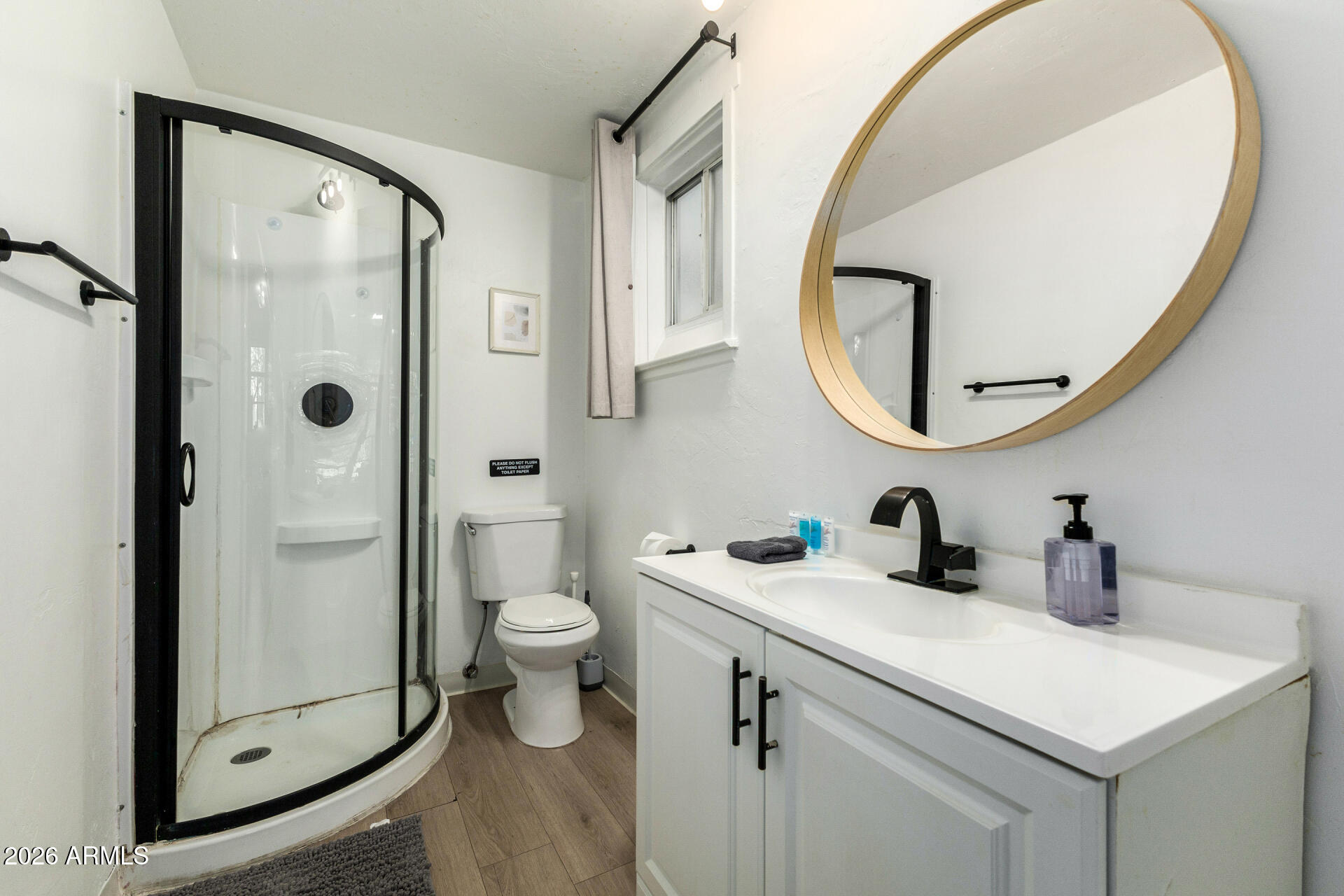 1317 West Monroe Street Phoenix, AZ 85007 - Photo 39 of 86 a bathroom with a sink a toilet and a mirror